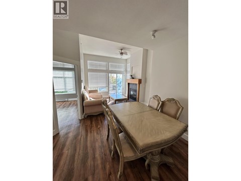 A dining room with a table and chairs.
