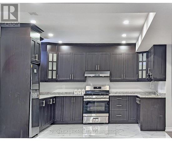 A modern kitchen with dark wood cabinets and stainless steel appliances.