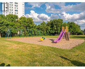A playground with a green swing set and a purple slide.