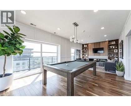 A pool table in a room with a view of the city.