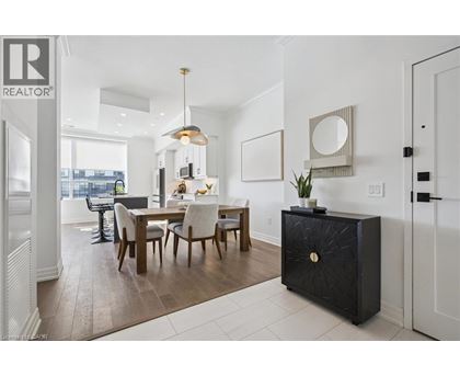 A modern dining room with a wooden table and chairs.