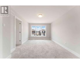A white room with a window showing a view of other buildings.