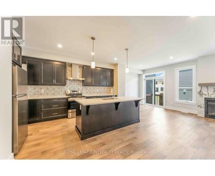 A modern kitchen with dark wood cabinets and a central island.