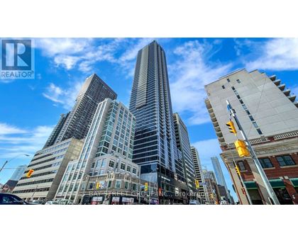 A cityscape with a tall building in the center and a street sign that reads "Brokerage.".