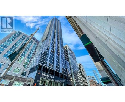 A tall building with a glass facade is the focal point of the image.