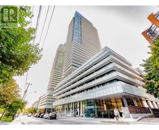 A modern multi-story building with a glass facade is the focal point of the image.