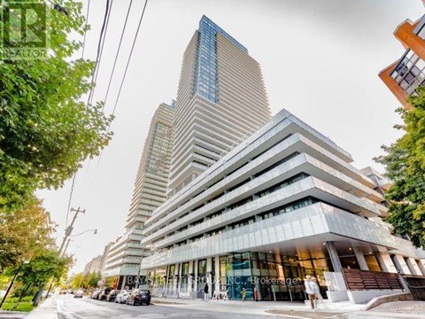 A modern multi-story building with a glass facade is the focal point of the image.