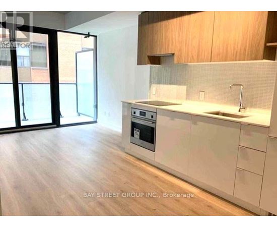 A modern kitchen with a stove top oven and a sink.