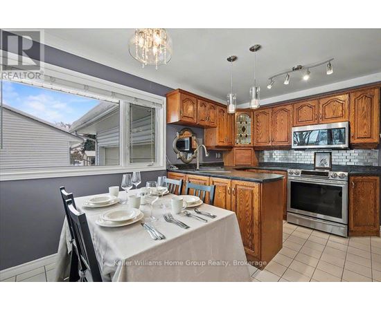 A kitchen with a table set for a meal.