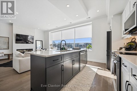 A modern kitchen with dark wood cabinets and a white countertop.