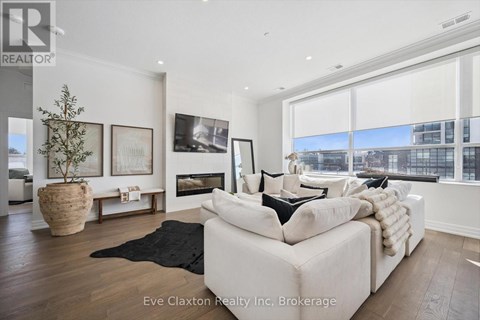 A modern living room with a white sofa and a black rug.