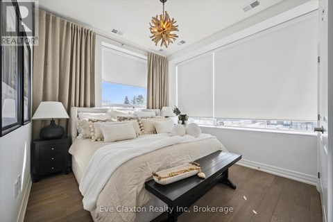 A bedroom with a large bed and a view of the outdoors.