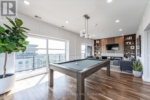 A pool table in a room with a view of the city.