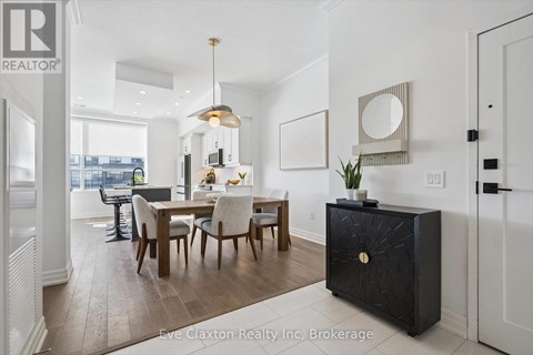 A dining room with a wooden table and chairs.