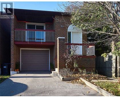 A brick house with a balcony and a garage door.
