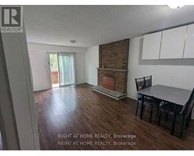A room with a fireplace and a dining table.