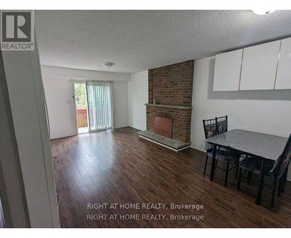 A room with a fireplace and a dining table.