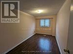 A room with a wooden floor and a window.