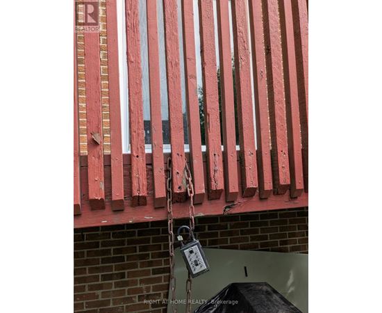 A red fence with a padlock hanging from it.
