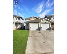 A realtor logo is displayed on a photo of a house.