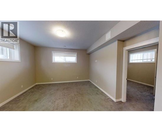 A room with a carpeted floor and a window.