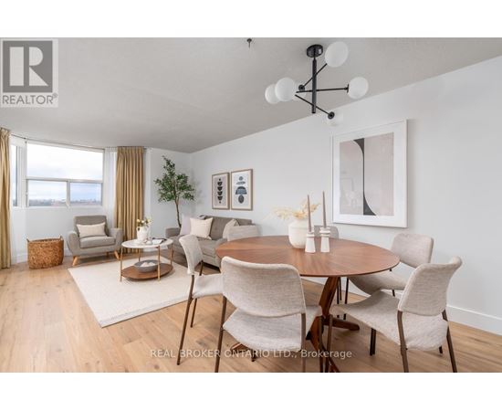 A dining room with a round table and chairs.