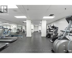 A gym with treadmills, weights and other exercise equipment.