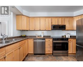A kitchen with wooden cabinets and stainless steel appliances.