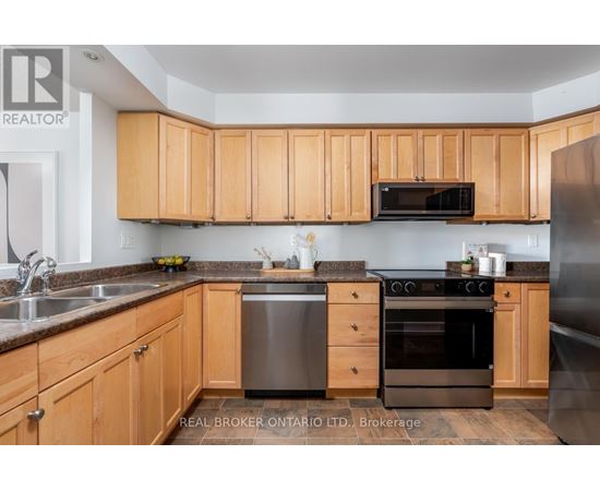 A kitchen with wooden cabinets and stainless steel appliances.