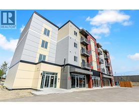 A modern apartment building with a clear blue sky in the background.