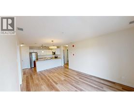 A large empty room with wooden floors and white walls.