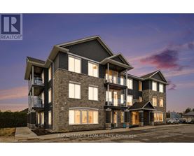 A modern multi-story residential building with balconies and large windows.