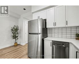 A kitchen with a stainless steel refrigerator and a dishwasher.