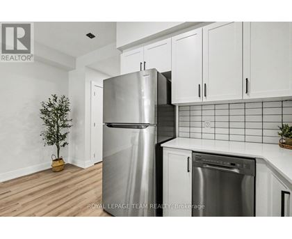 A kitchen with a stainless steel refrigerator and a dishwasher.