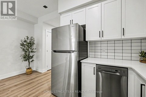 A kitchen with a stainless steel refrigerator and a dishwasher.