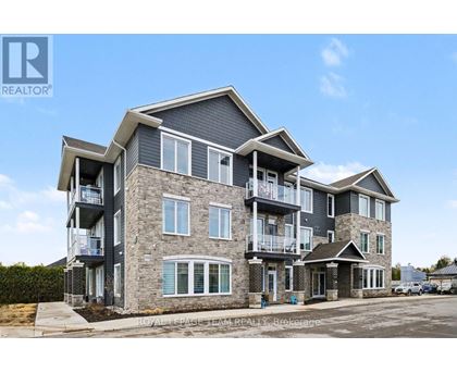 A large, modern multi-story residential building with balconies and multiple windows.