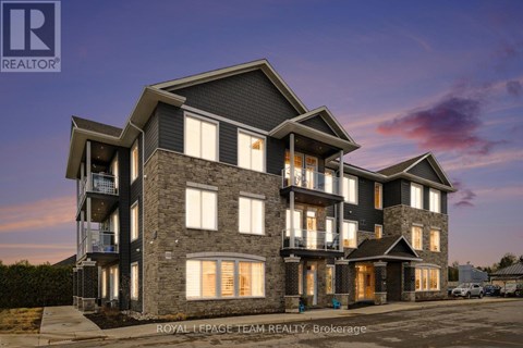 A modern multi-story residential building with balconies and large windows.