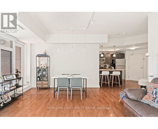 A living room with a dining table and chairs.
