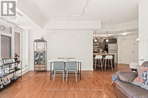 A living room with a dining table and chairs.