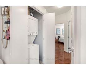 A white refrigerator is in a kitchen with a white door.