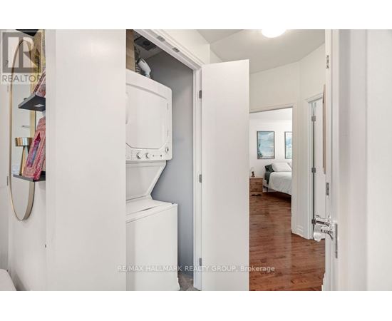 A white refrigerator is in a kitchen with a white door.