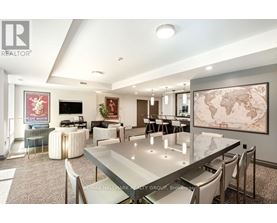 A modern dining room with a glass table and chairs.