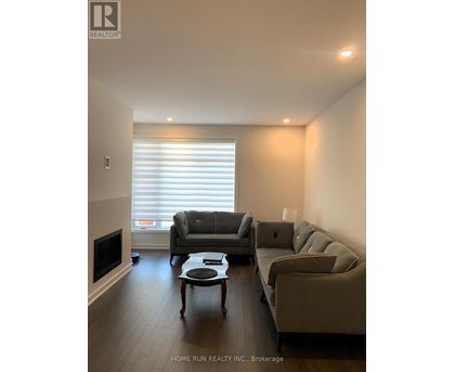 A living room with a grey couch and a coffee table.