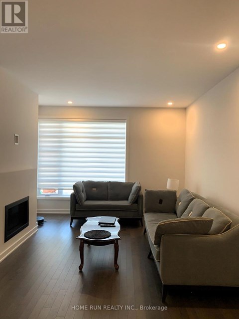 A living room with a grey couch and a coffee table.