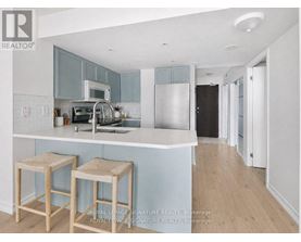 A kitchen with a white counter top and blue cabinets.