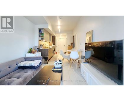 A living room with a grey couch and a black coffee table.