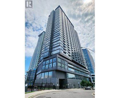 A tall building with a black fence in front of it.