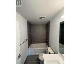A bathroom with a toilet, sink, and bathtub.
