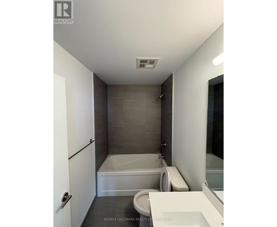 A bathroom with a toilet, sink, and bathtub.