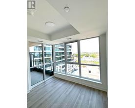 A room with a large window overlooking a cityscape.